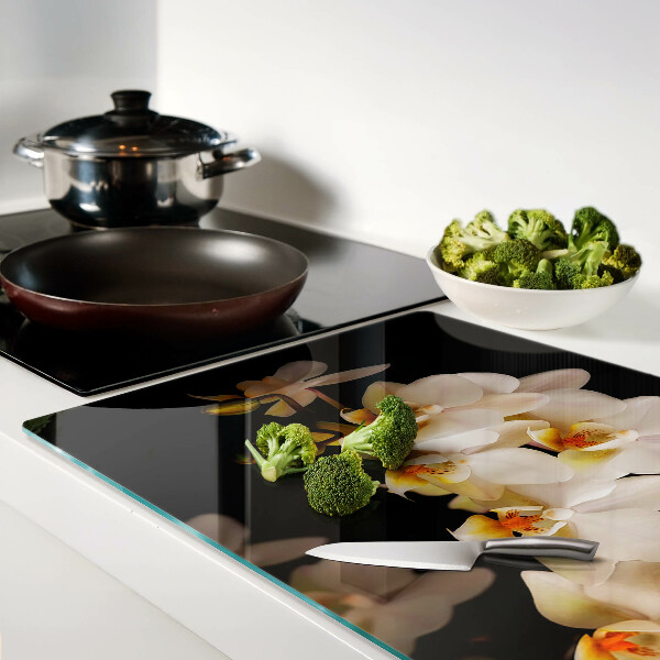 Tagliere in vetro con stampa di orchidee su sfondo nero