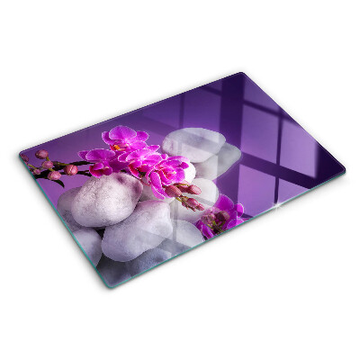 Tagliere in vetro temperato con motivo di fiori di orchidea su sfondo pietre
