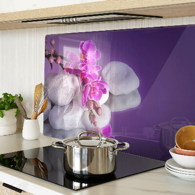 Tagliere in vetro temperato con motivo di fiori di orchidea su sfondo pietre