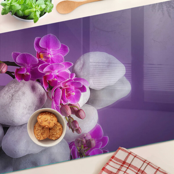 Tagliere in vetro temperato con motivo di fiori di orchidea su sfondo pietre