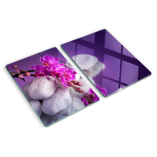 Tagliere in vetro temperato con motivo di fiori di orchidea su sfondo pietre