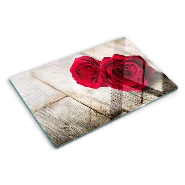Tagliere in vetro con stampa di rose rosse su sfondo di legno