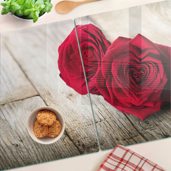 Tagliere in vetro con stampa di rose rosse su sfondo di legno