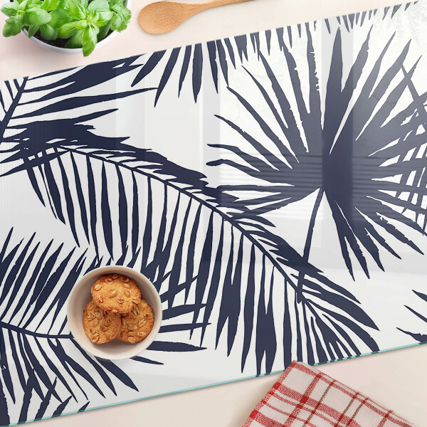 Tagliere in vetro con stampa di foglie di palma su sfondo bianco