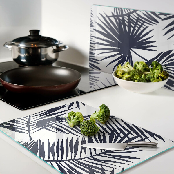 Tagliere in vetro con stampa di foglie di palma su sfondo bianco