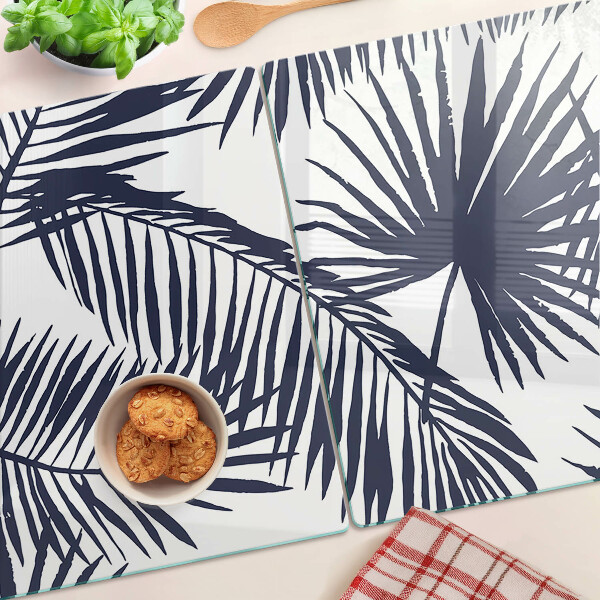 Tagliere in vetro con stampa di foglie di palma su sfondo bianco