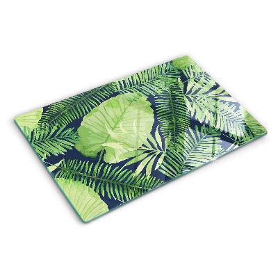 Tagliere in vetro temperato con motivo di foglie tropicali su sfondo scuro