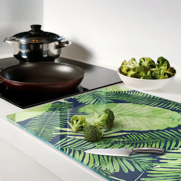 Tagliere in vetro temperato con motivo di foglie tropicali su sfondo scuro