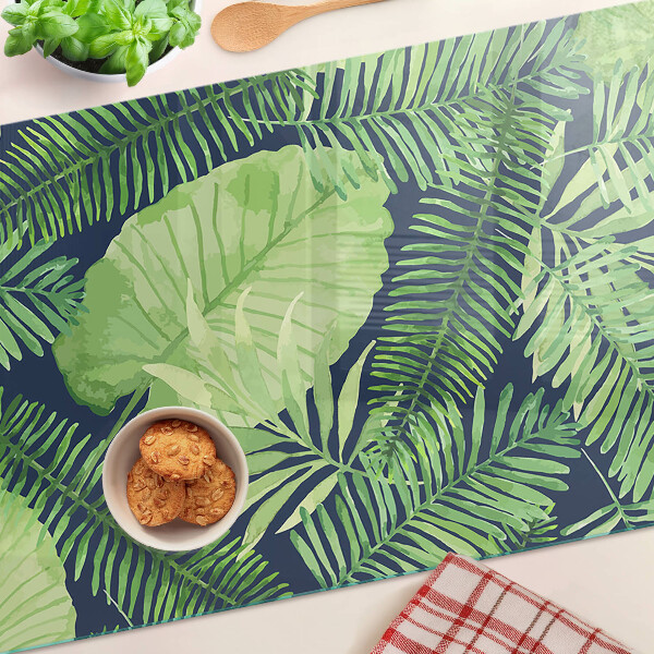 Tagliere in vetro temperato con motivo di foglie tropicali su sfondo scuro