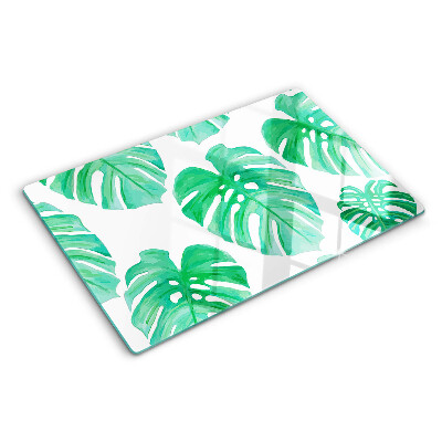 Tagliere in vetro con motivo di foglie di monstera su sfondo bianco