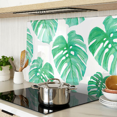 Tagliere in vetro con motivo di foglie di monstera su sfondo bianco