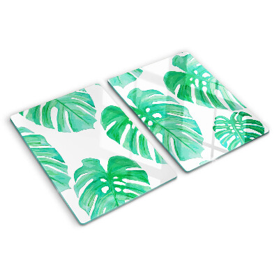 Tagliere in vetro con motivo di foglie di monstera su sfondo bianco