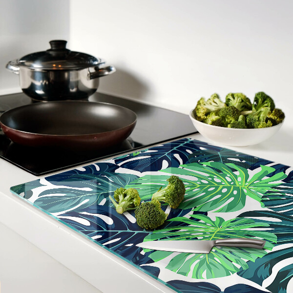 Tagliere in vetro con stampa a motivo di foglie di Monstera su sfondo tropicale