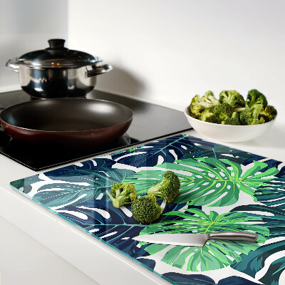 Tagliere in vetro con stampa a motivo di foglie di Monstera su sfondo tropicale