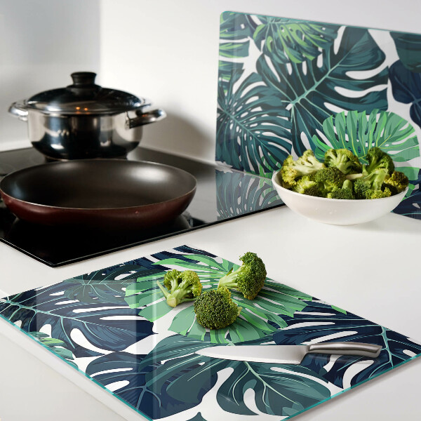 Tagliere in vetro con stampa a motivo di foglie di Monstera su sfondo tropicale