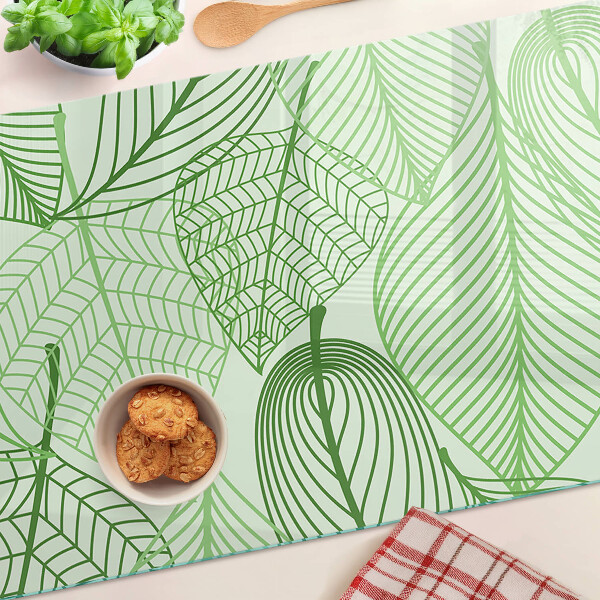 Tagliere in vetro con motivo di foglie nei toni del verde