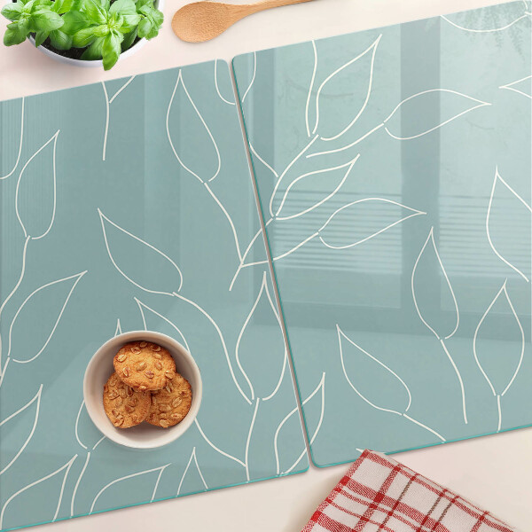 Tagliere in vetro temperato con motivo a foglie sullo sfondo