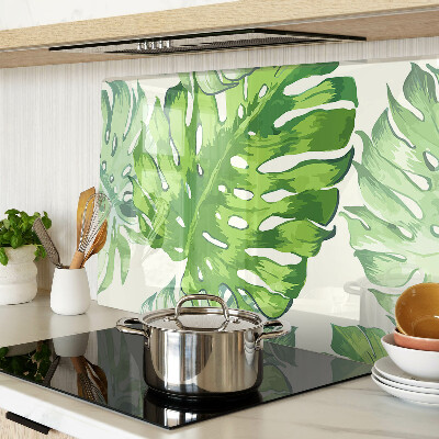 Tagliere in vetro temperato con motivo di foglie di monstera su sfondo chiaro