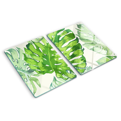 Tagliere in vetro temperato con motivo di foglie di monstera su sfondo chiaro