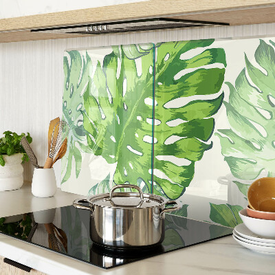 Tagliere in vetro temperato con motivo di foglie di monstera su sfondo chiaro