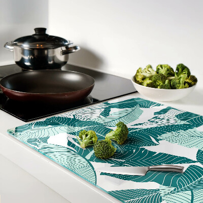 Tagliere in vetro con motivo di foglie tropicali nei toni del verde