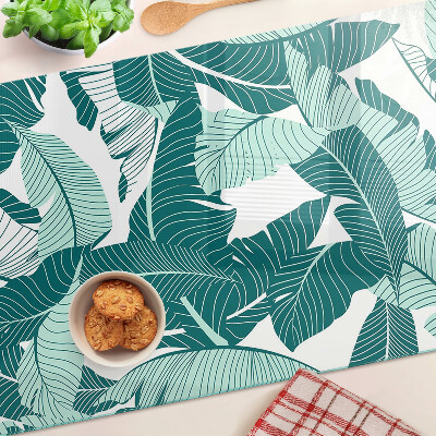 Tagliere in vetro con motivo di foglie tropicali nei toni del verde