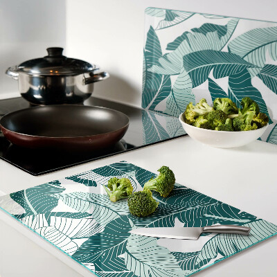 Tagliere in vetro con motivo di foglie tropicali nei toni del verde