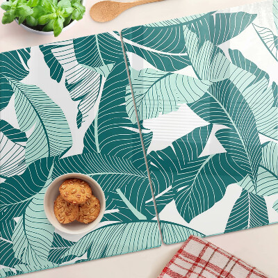 Tagliere in vetro con motivo di foglie tropicali nei toni del verde