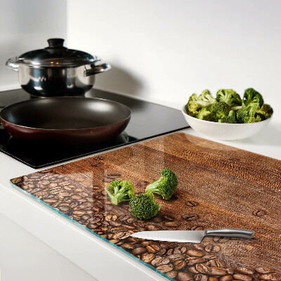 Tagliere in vetro temperato con stampa di chicchi di caffè su sfondo di legno