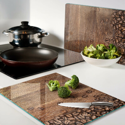 Tagliere in vetro temperato con stampa di chicchi di caffè su sfondo di legno