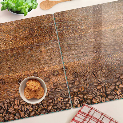 Tagliere in vetro temperato con stampa di chicchi di caffè su sfondo di legno