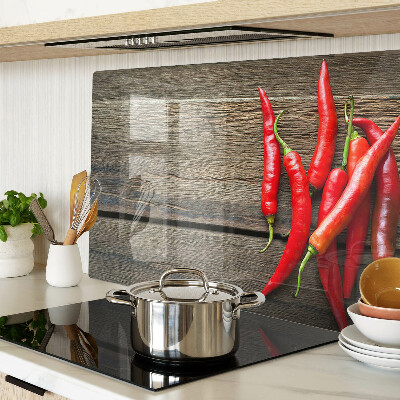 Tagliere in vetro temperato con motivo di peperoncini su sfondo di legno