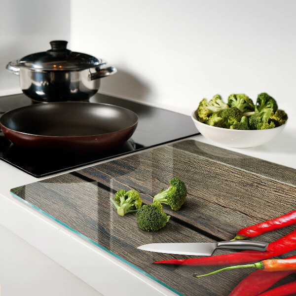 Tagliere in vetro temperato con motivo di peperoncini su sfondo di legno