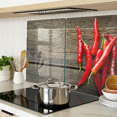 Tagliere in vetro temperato con motivo di peperoncini su sfondo di legno