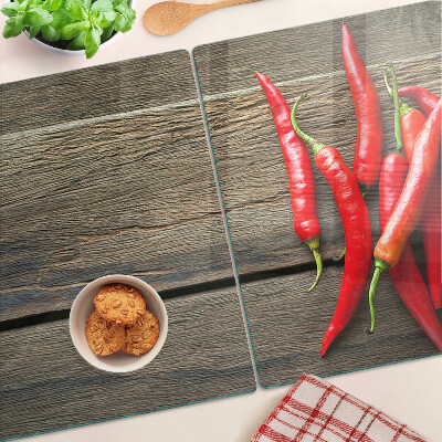 Tagliere in vetro temperato con motivo di peperoncini su sfondo di legno