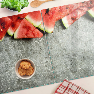 Tagliere in vetro temperato con decorazione a fette di anguria su sfondo grigio