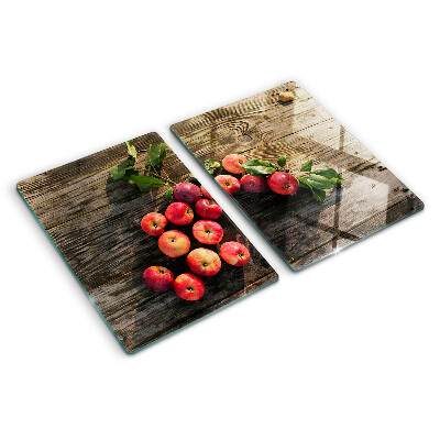 Tagliere in vetro con stampa di mele su sfondo di legno