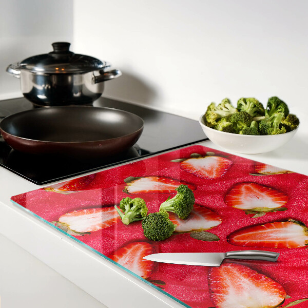 Tagliere in vetro temperato con decorazione di fragole su sfondo rosa