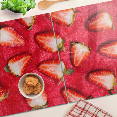 Tagliere in vetro temperato con decorazione di fragole su sfondo rosa