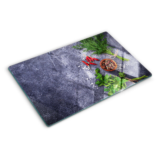 Tagliere in vetro con motivo di erbe e spezie su sfondo effetto pietra