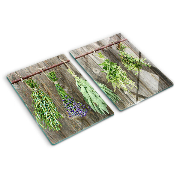 Tagliere in vetro con stampa di erbe su sfondo di legno