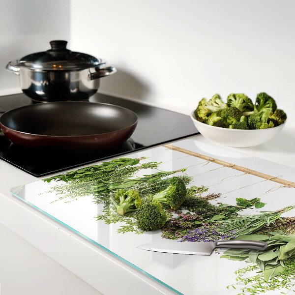 Tagliere in vetro temperato con stampa di erbe essiccate su sfondo a spago