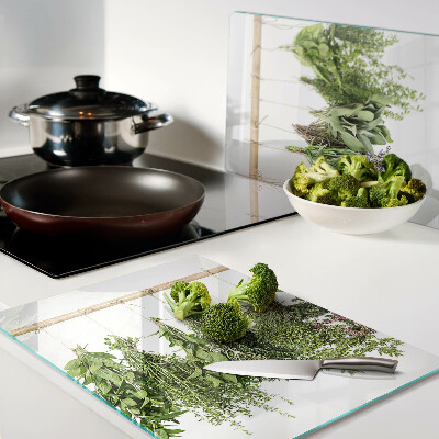 Tagliere in vetro temperato con stampa di erbe essiccate su sfondo a spago