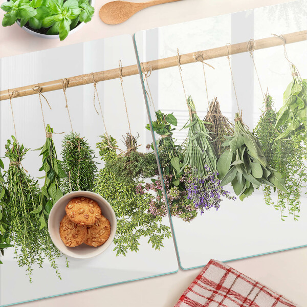 Tagliere in vetro temperato con stampa di erbe essiccate su sfondo a spago