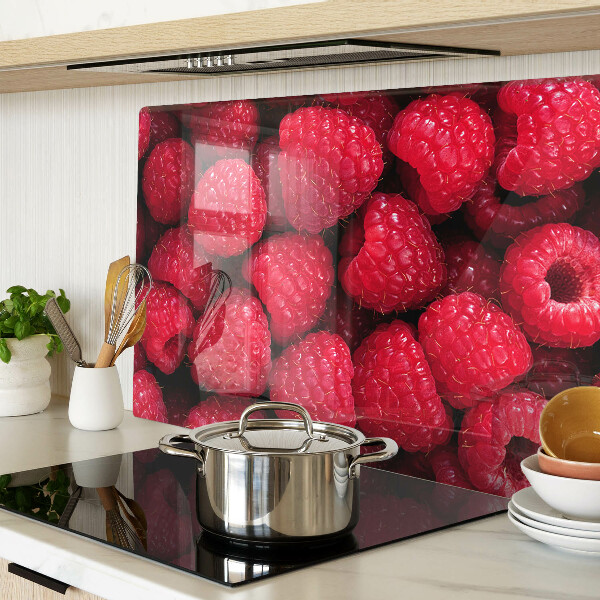 Tagliere in vetro temperato con stampa di lamponi sullo sfondo