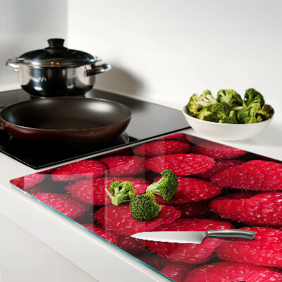 Tagliere in vetro temperato con stampa di lamponi sullo sfondo