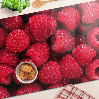 Tagliere in vetro temperato con stampa di lamponi sullo sfondo