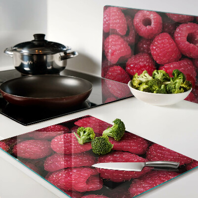 Tagliere in vetro temperato con stampa di lamponi sullo sfondo