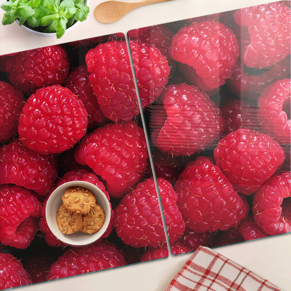 Tagliere in vetro temperato con stampa di lamponi sullo sfondo