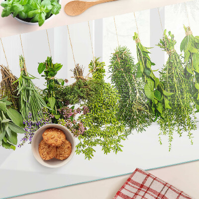 Tagliere in vetro con stampa di erbe appese su spago